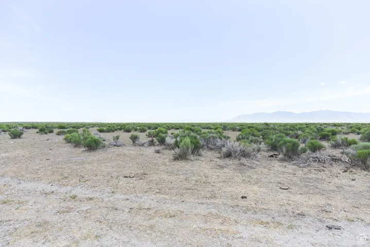 View of undeveloped land with a mountainous background and rural landscape