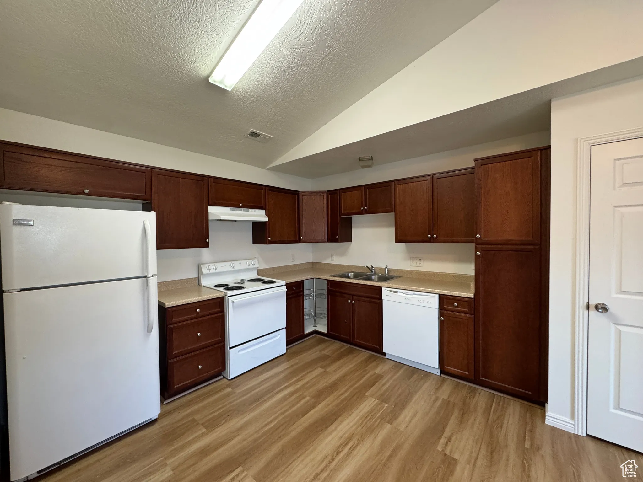 Kitchen with New LVP & Vaulted Ceiling