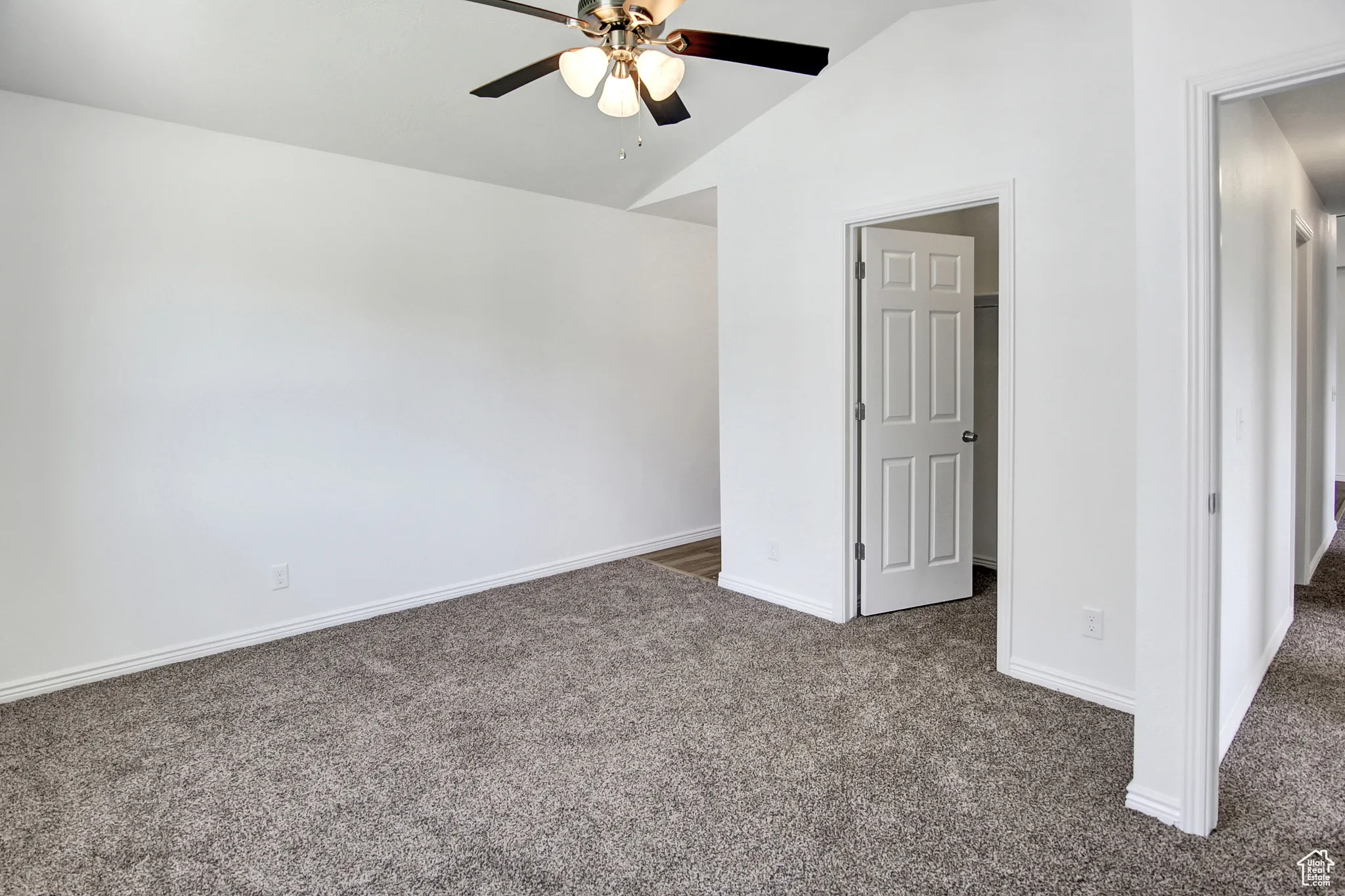 Primary Bedroom with Vaulted ceiling, ceiling fan, walk-in closet, new paint & new carpet