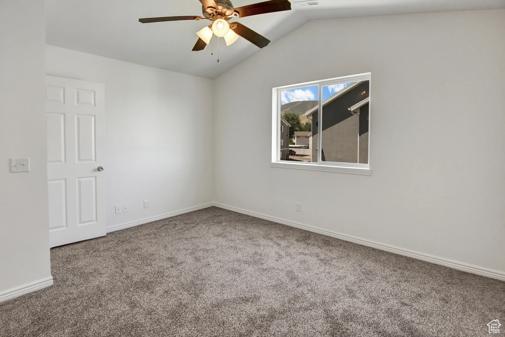 Primary Bedroom with Vaulted ceiling, ceiling fan, walk-in closet, new paint & new carpet