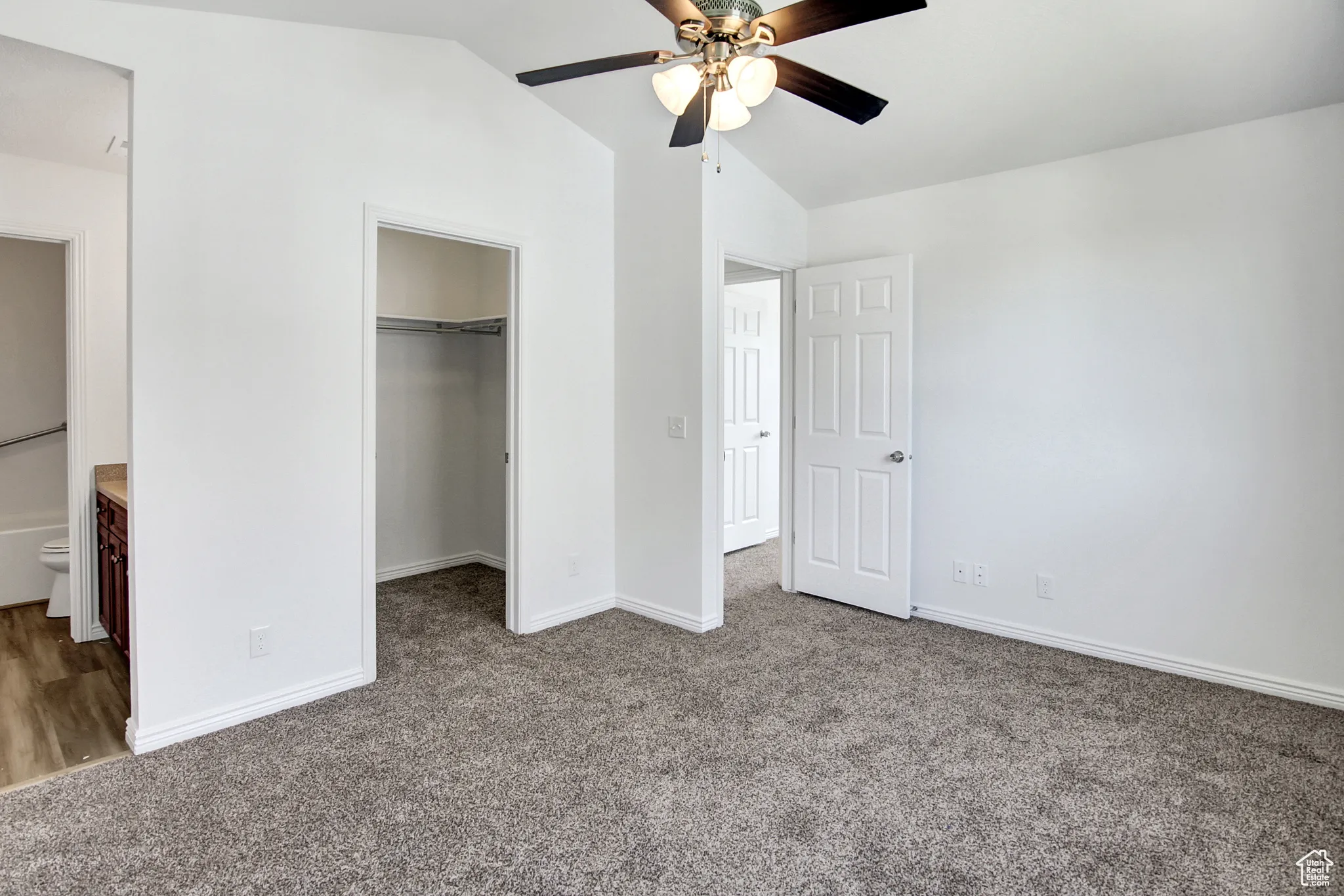 Primary Bedroom with Vaulted ceiling, ceiling fan, walk-in closet, new paint & new carpet
