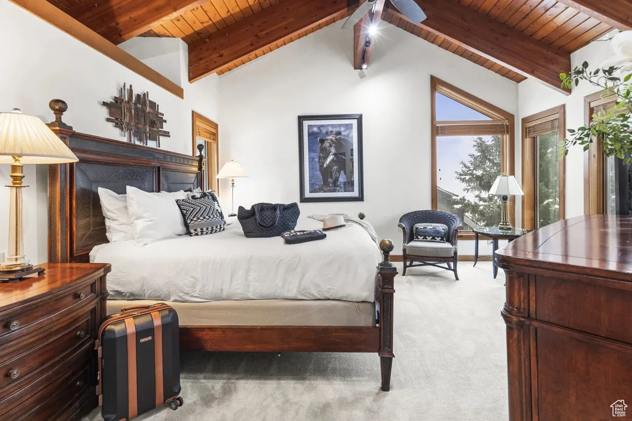 Bedroom with wood ceiling and carpet
