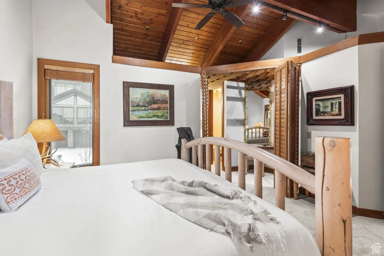 Bedroom featuring wooden ceiling and carpet floors