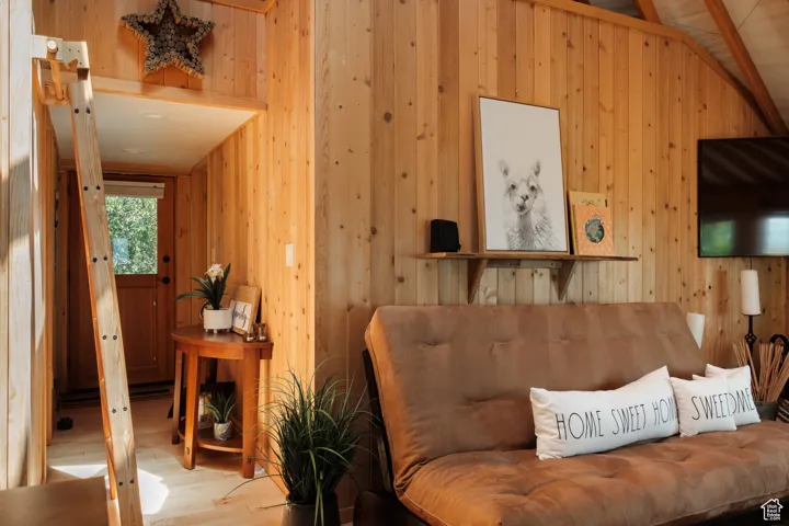 Living area with wood walls and wood finished floors