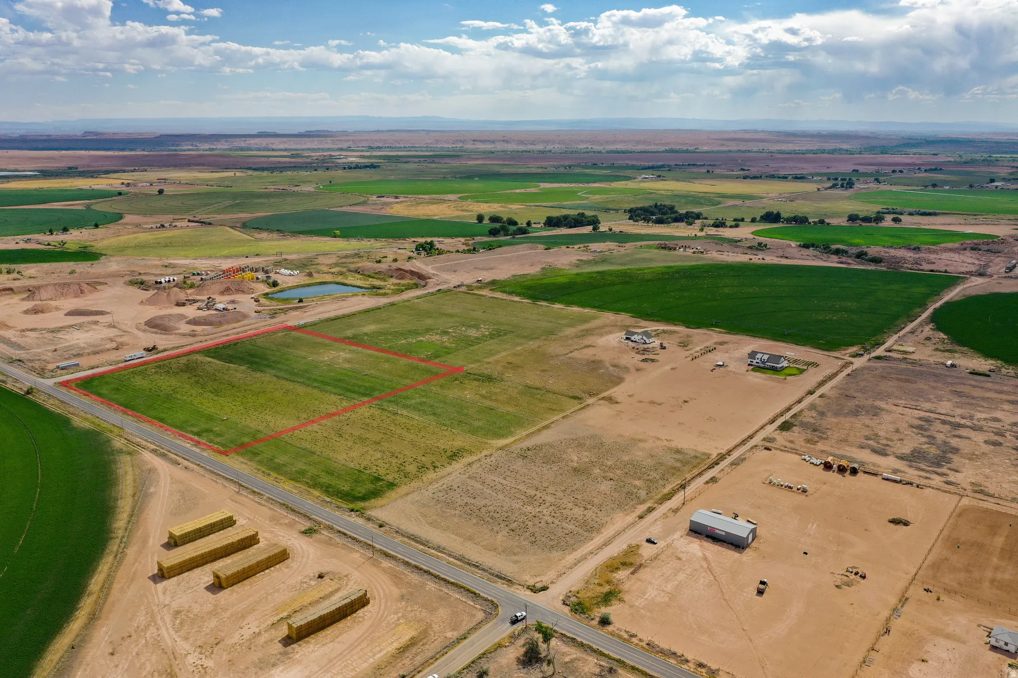 Expansive rural land parcel featuring a rectangular shape and direct road frontage