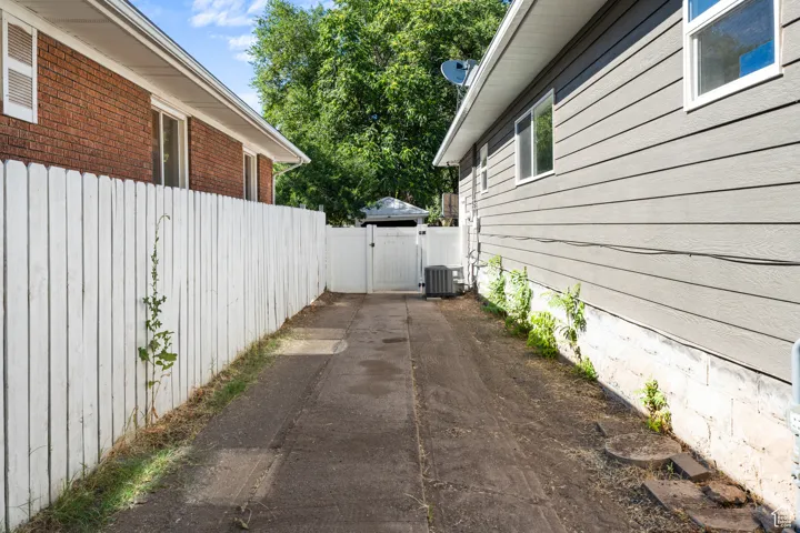 View of property exterior featuring a gate and brick siding