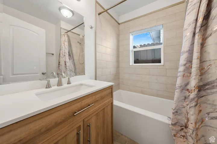 Full bathroom with vanity and shower / tub combo