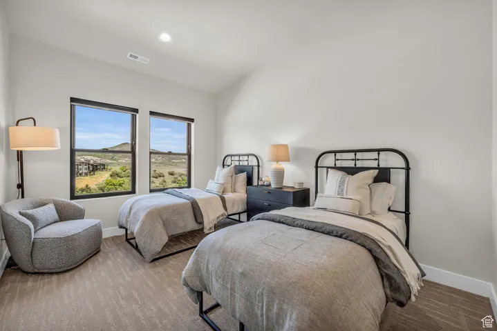 Bedroom with lofted ceiling, wood finished floors, and recessed lighting