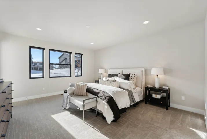 Carpeted bedroom with baseboards and recessed lighting