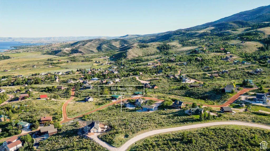 Aerial view of property and surrounding area with mountains