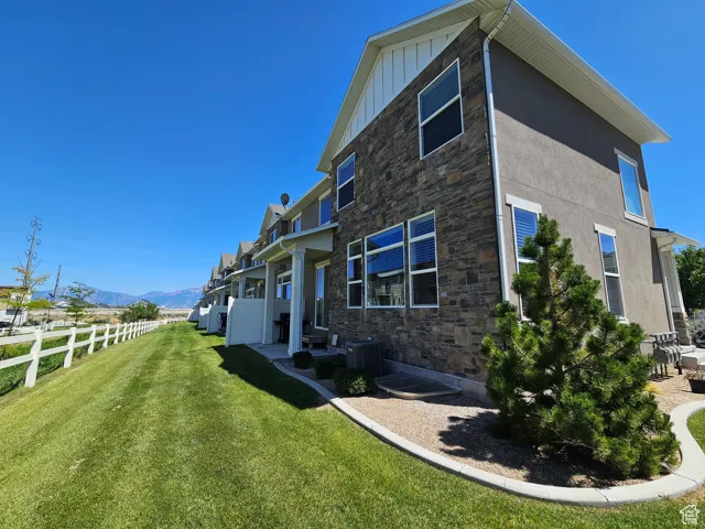 Rear view of property with stone siding, a mountain view, and board and batten siding