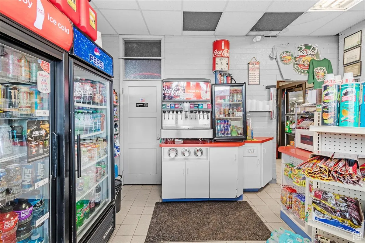 Misc room featuring a drop ceiling and light tile patterned flooring