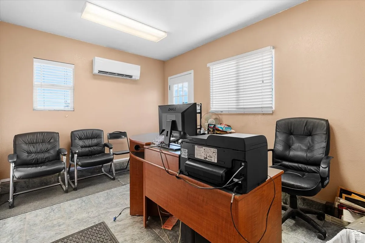 Home office featuring a wall unit AC and plenty of natural light