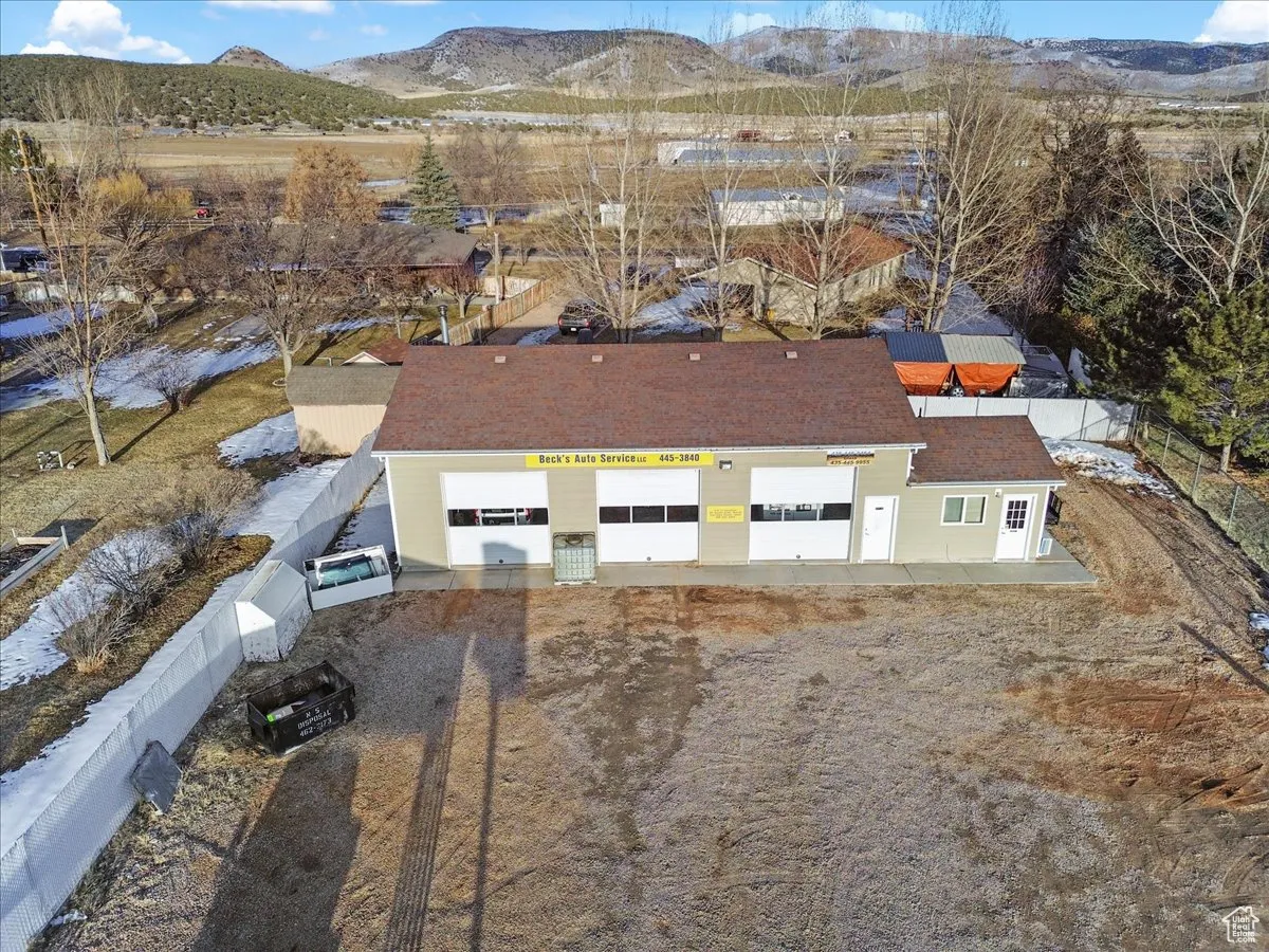 Aerial view of property and surrounding area featuring mountains