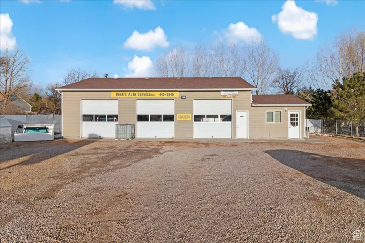 Detached garage with dirt driveway
