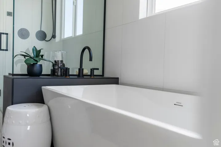 Bathroom featuring a freestanding bath and a sink