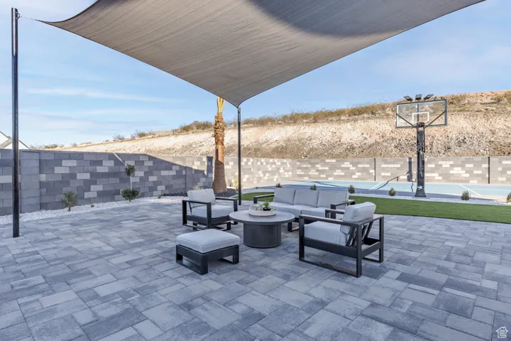 Fenced backyard featuring an outdoor living space, a patio area, and a swimming pool