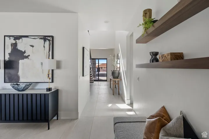 Hall featuring tile patterned floors and baseboards