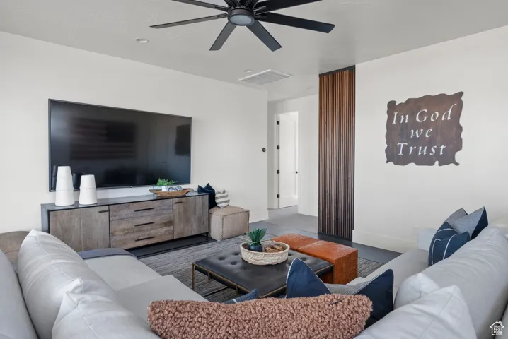 Living room with a ceiling fan and baseboards