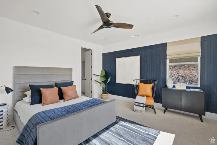 Carpeted bedroom featuring a ceiling fan