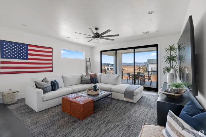 Living room featuring ceiling fan and recessed lighting