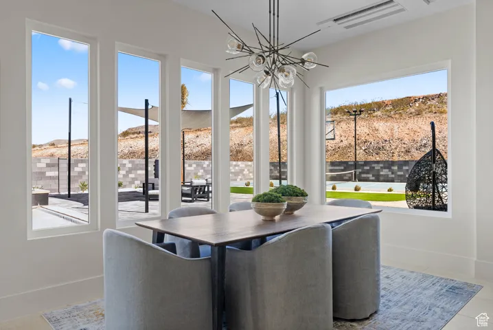Dining room with healthy amount of natural light, a chandelier, and a mountain view