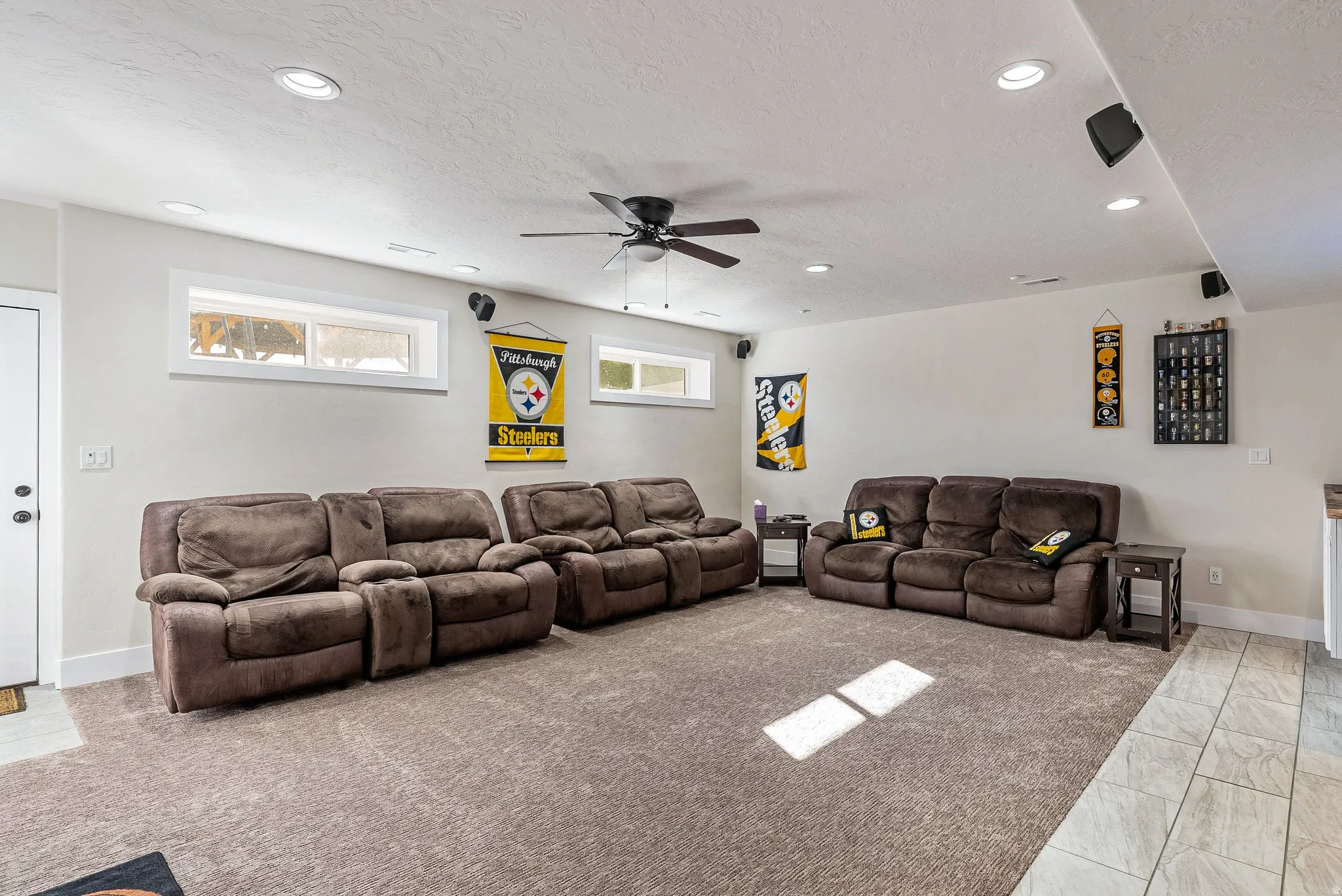 Spacious room featuring neutral carpeting, recessed lighting, a ceiling fan, and high-set windows