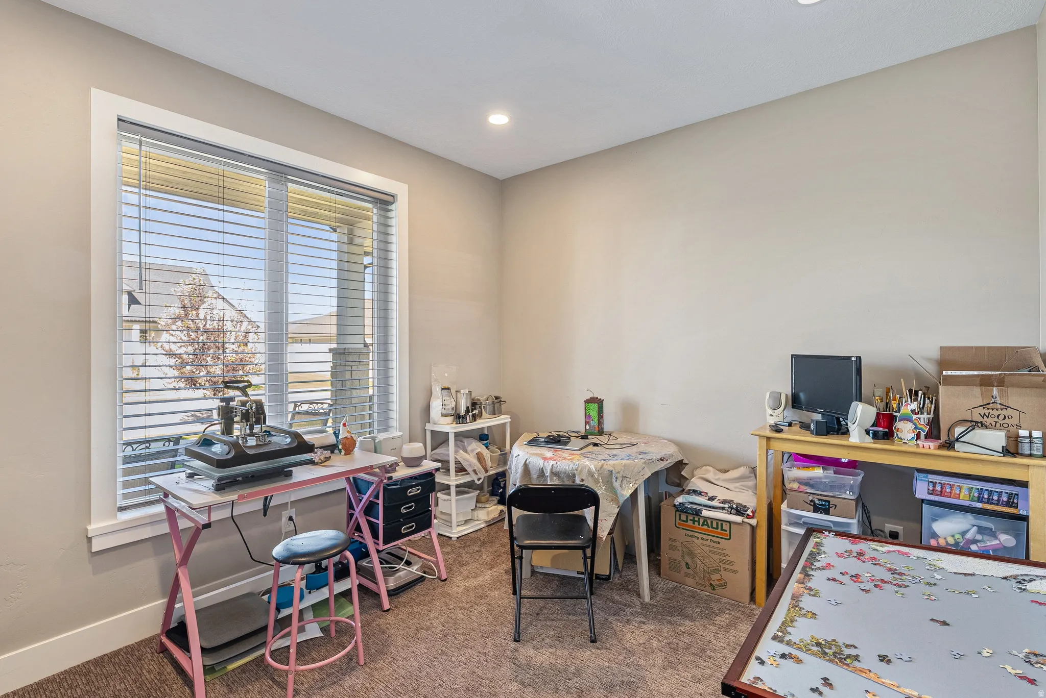 Neutral wall paint, recessed lighting, and carpeted flooring
