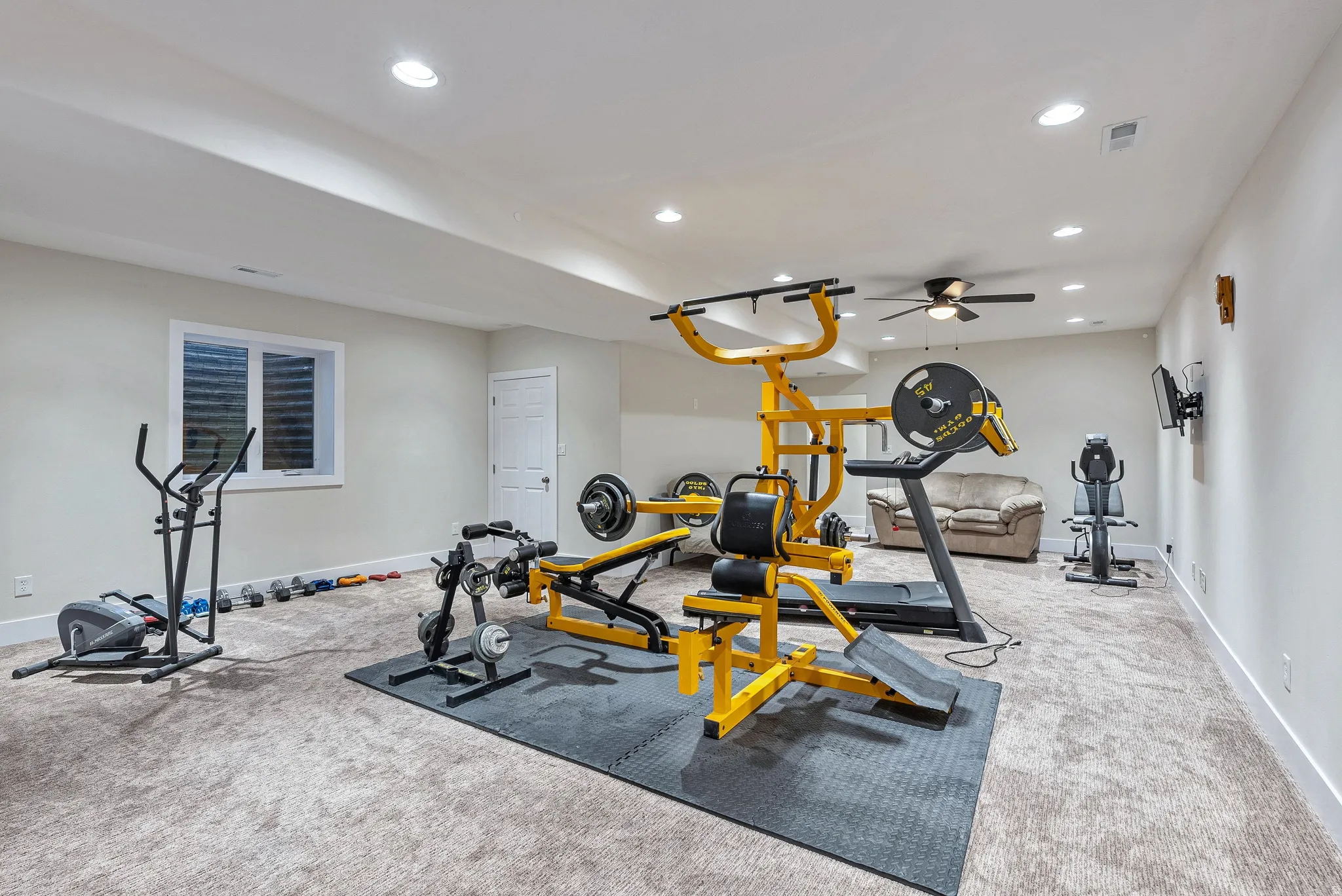 Spacious finished basement featuring recessed lighting, a ceiling fan, and carpeted flooring