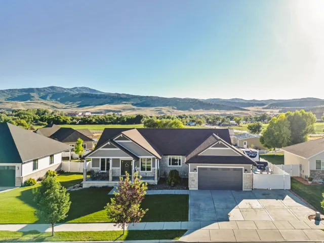 Contemporary ranch-style residence featuring a covered front porch, a two-car garage, and a concrete driveway
