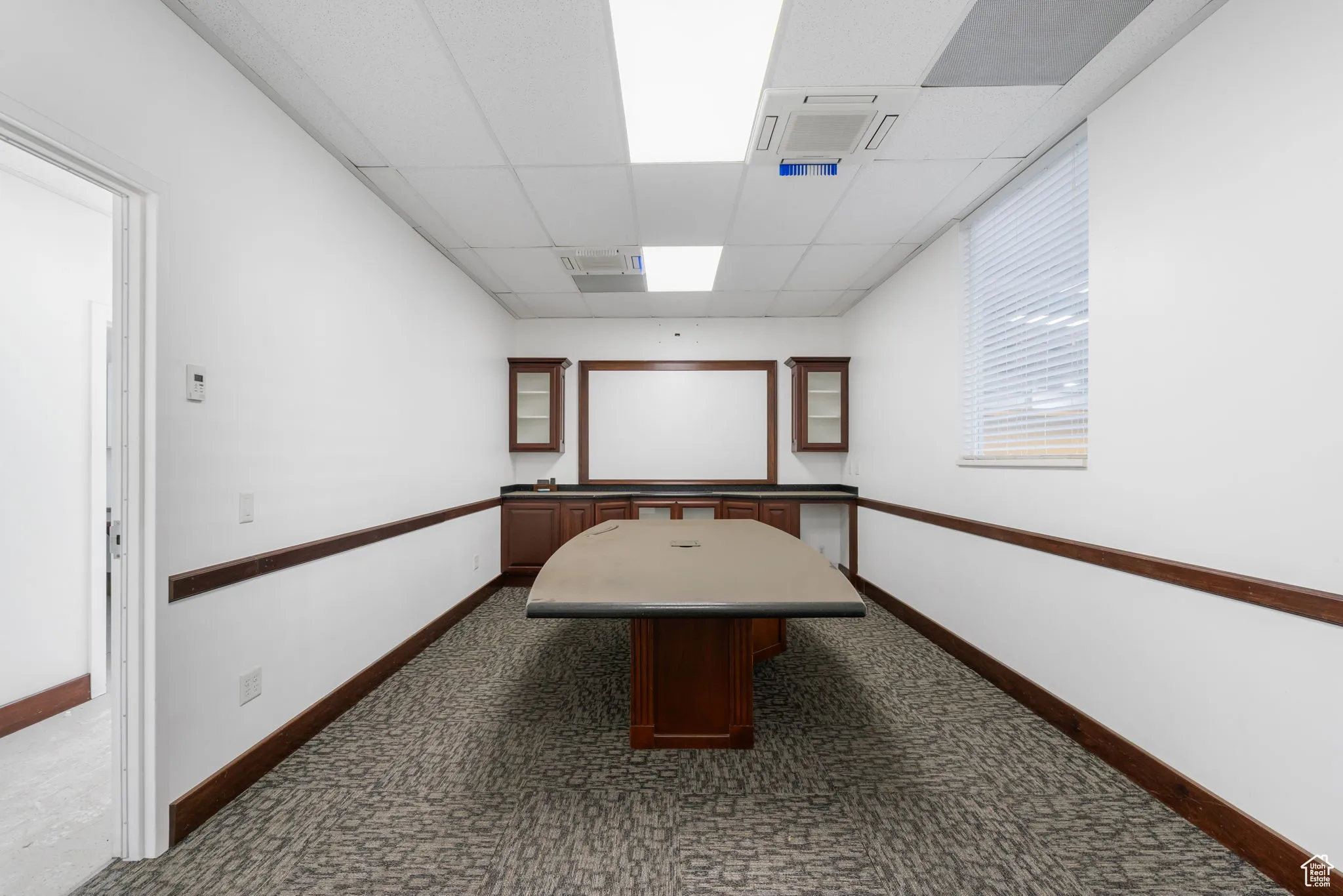 Game room with dark carpet and a paneled ceiling