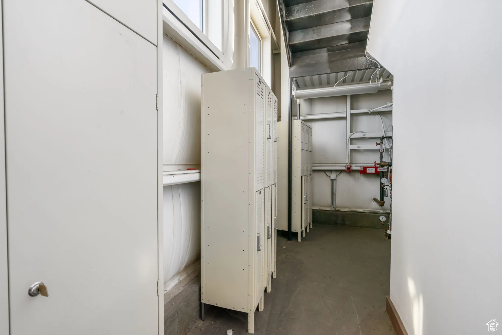 Hall with unfinished concrete flooring