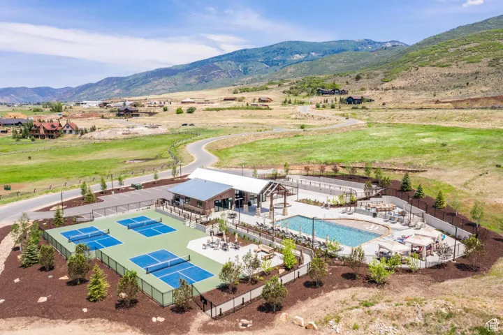 Drone / aerial view of a mountain backdrop and a pool area