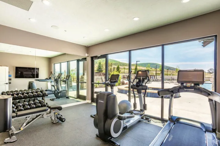 Exercise room with a mountain view, healthy amount of natural light, and recessed lighting