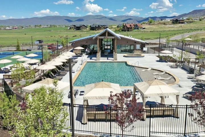 Community pool with a mountain view, a hot tub, and a patio area