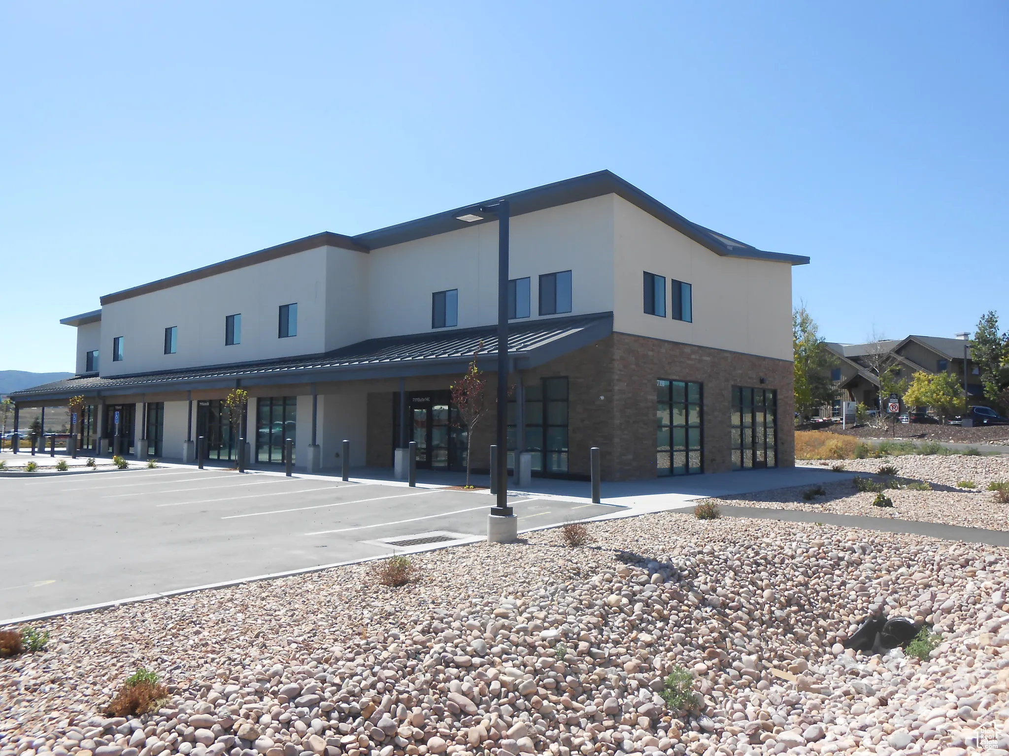 View of property featuring uncovered parking