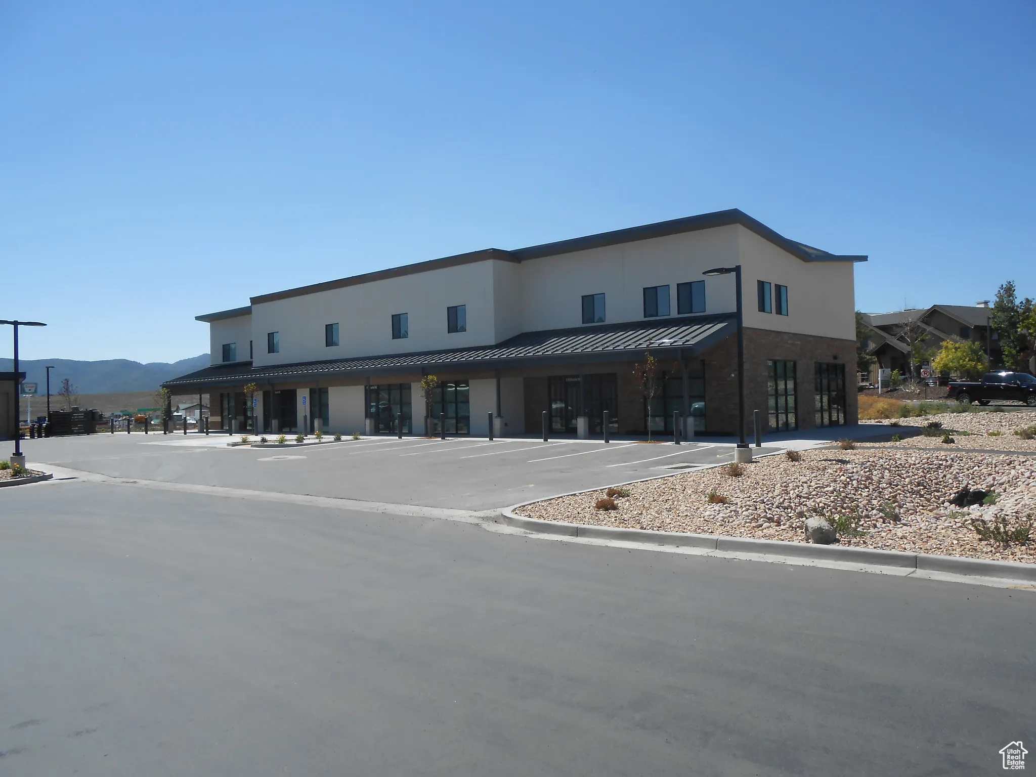 View of property featuring a mountain view and uncovered parking