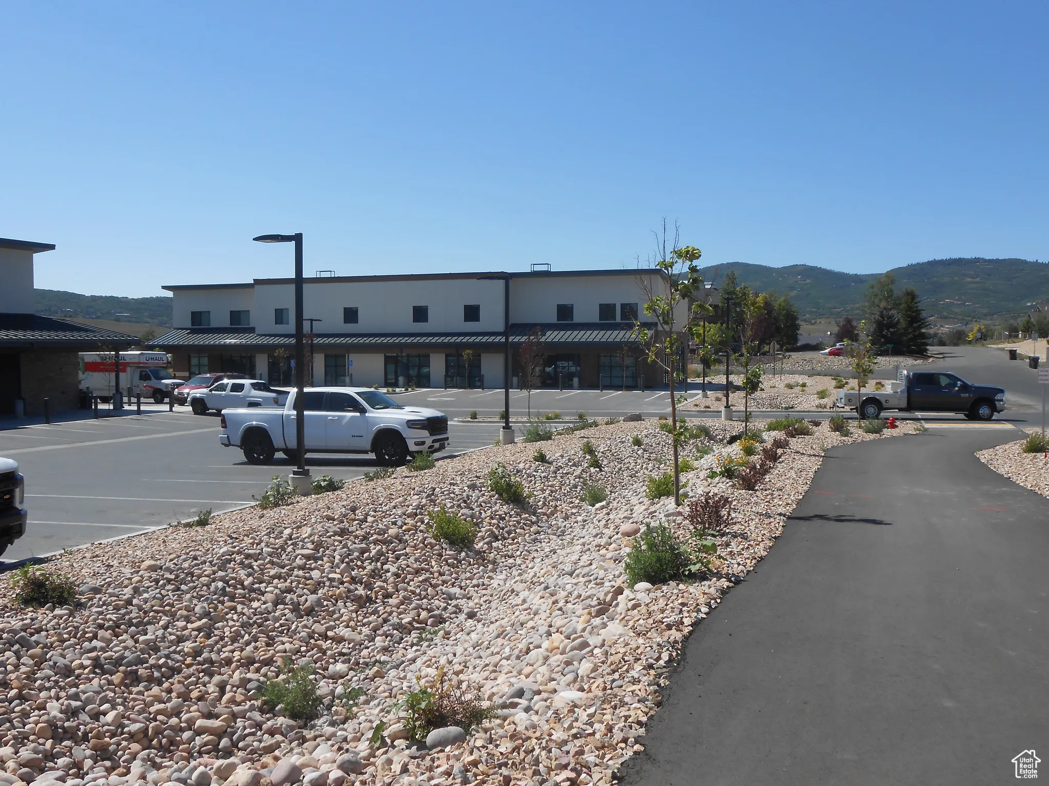View of building exterior with a mountain view and uncovered parking