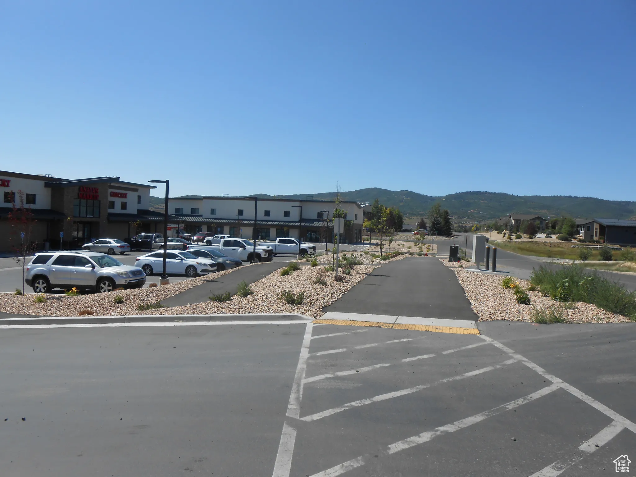Uncovered parking lot featuring a mountain view and a residential view
