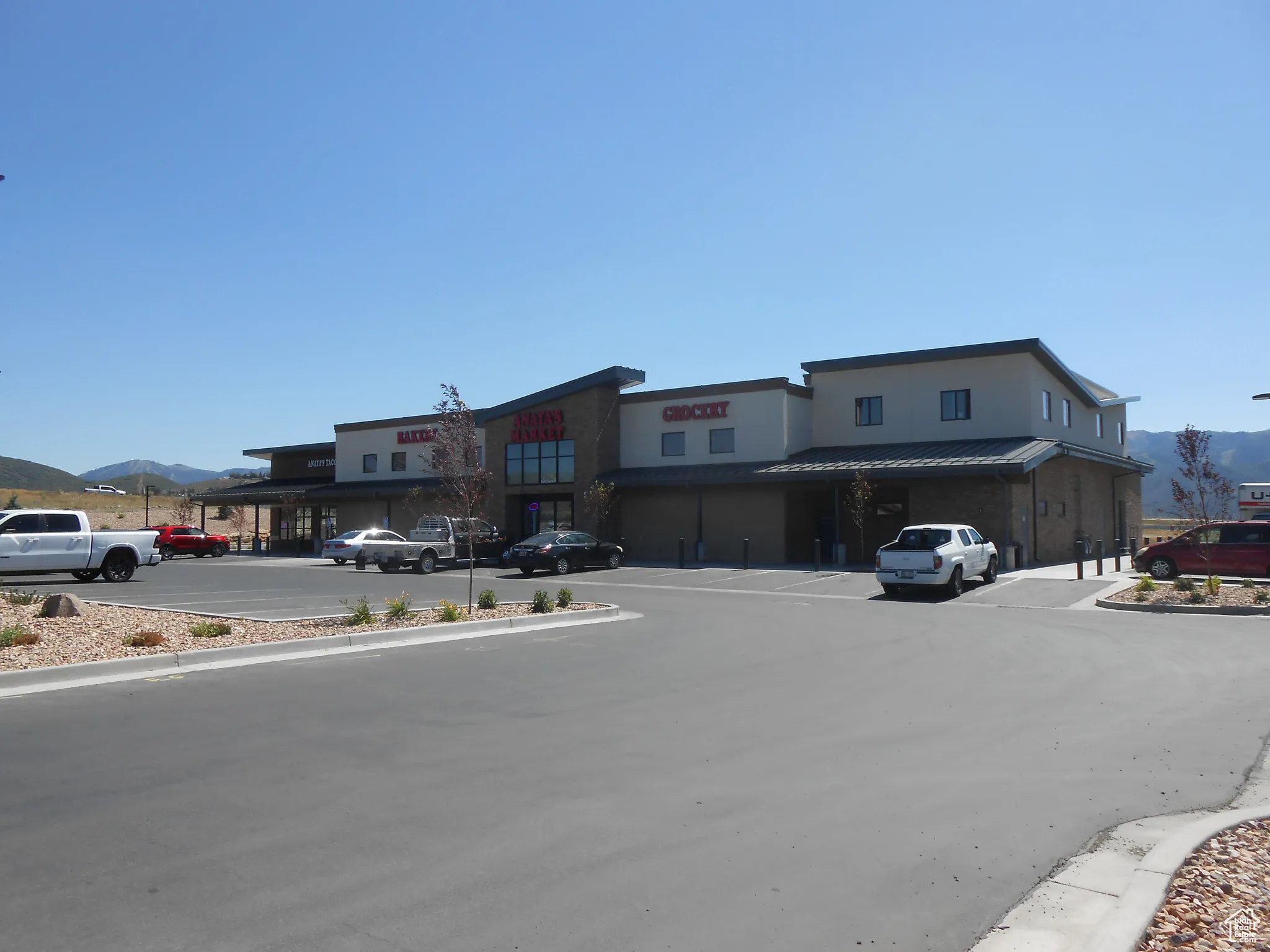View of asphalt street featuring a mountain view and curbs