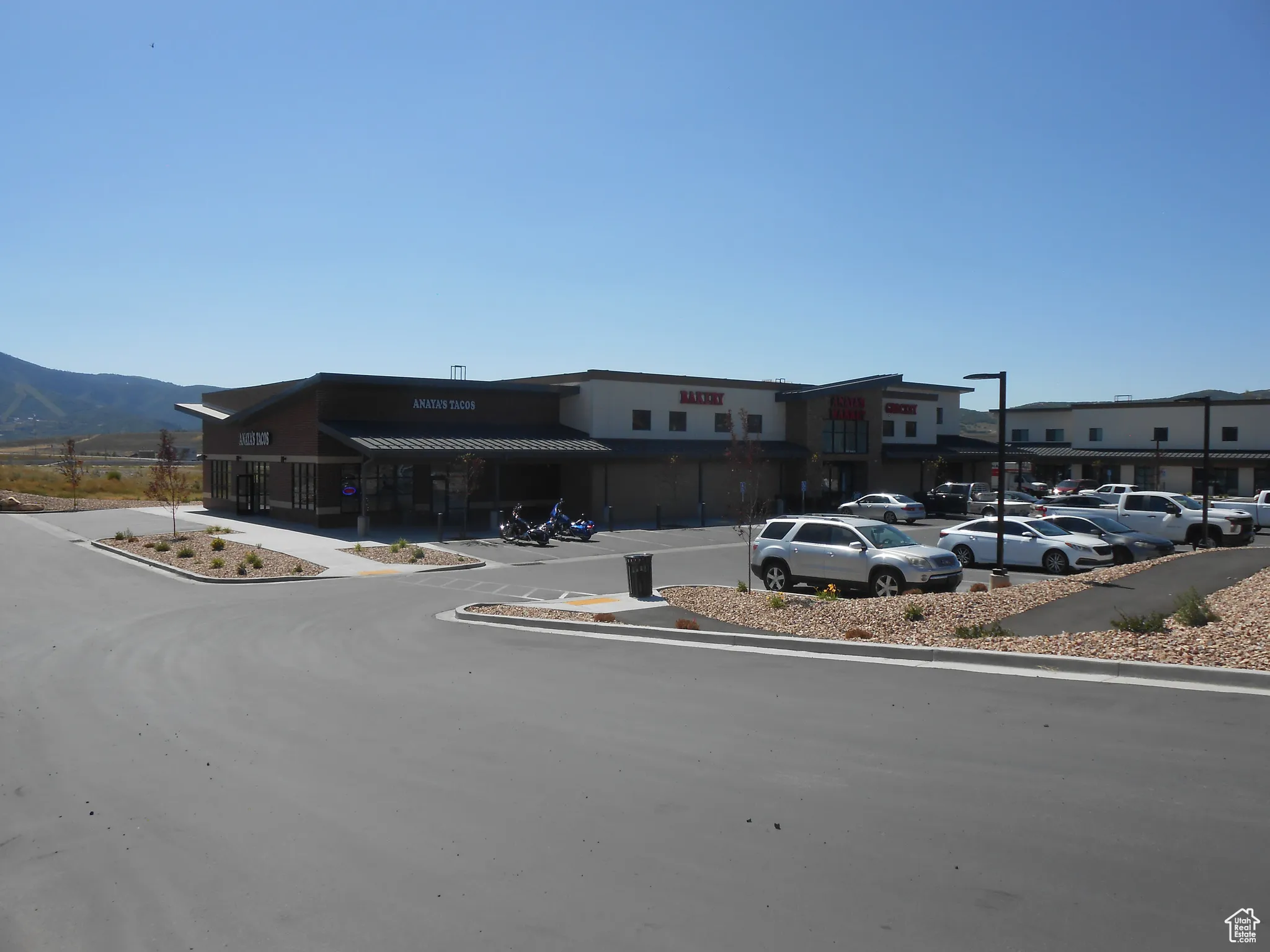 View of building exterior featuring uncovered parking and a mountain view