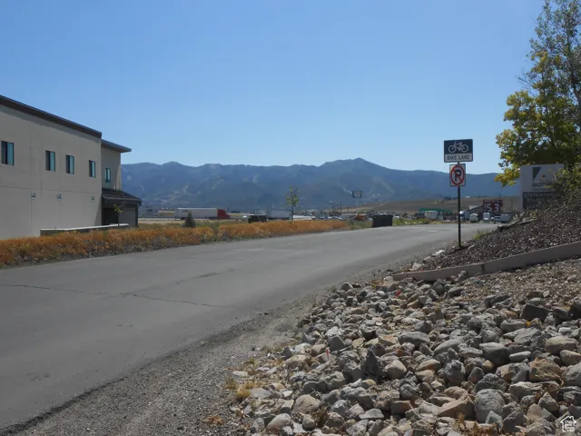 View of asphalt road with traffic signs and a mountain view