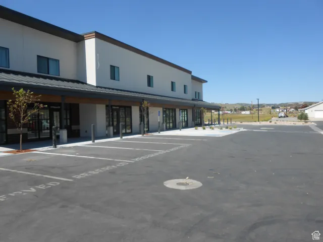 View of property with uncovered parking