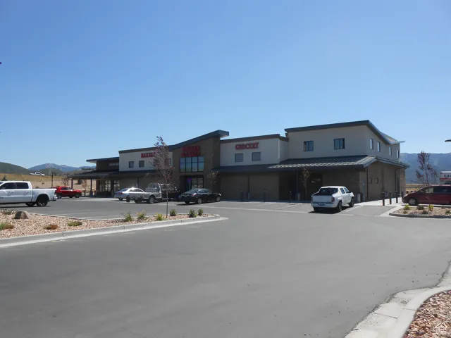 View of asphalt street featuring a mountain view and curbs