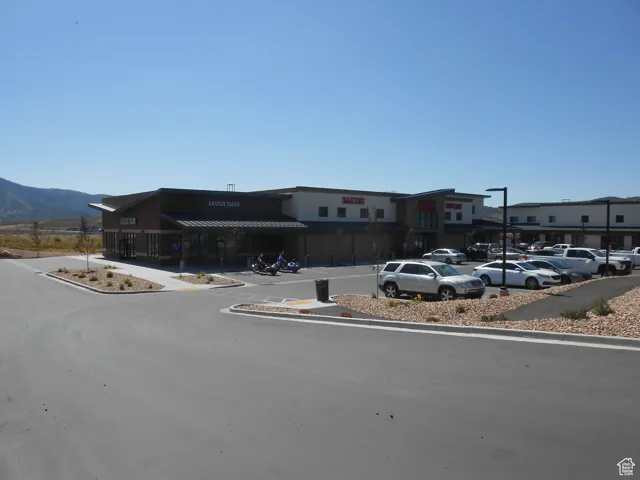 View of building exterior featuring uncovered parking and a mountain view