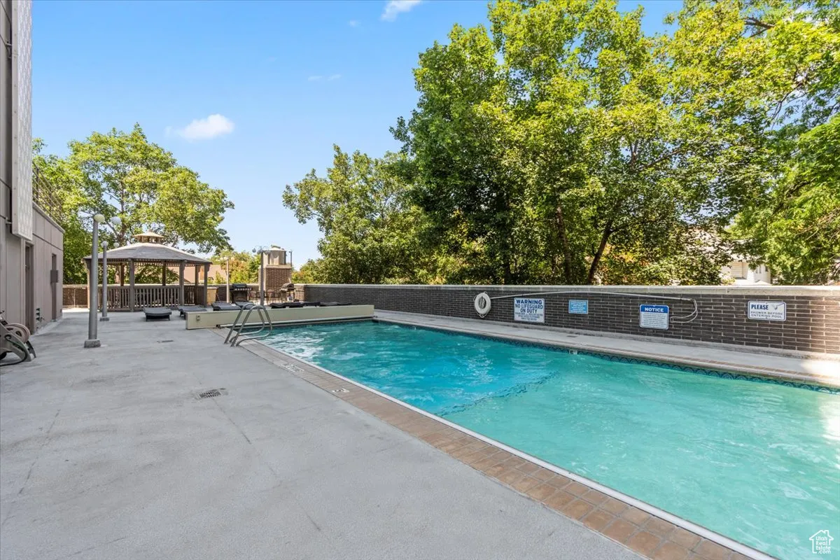 Community pool with a gazebo and a patio area