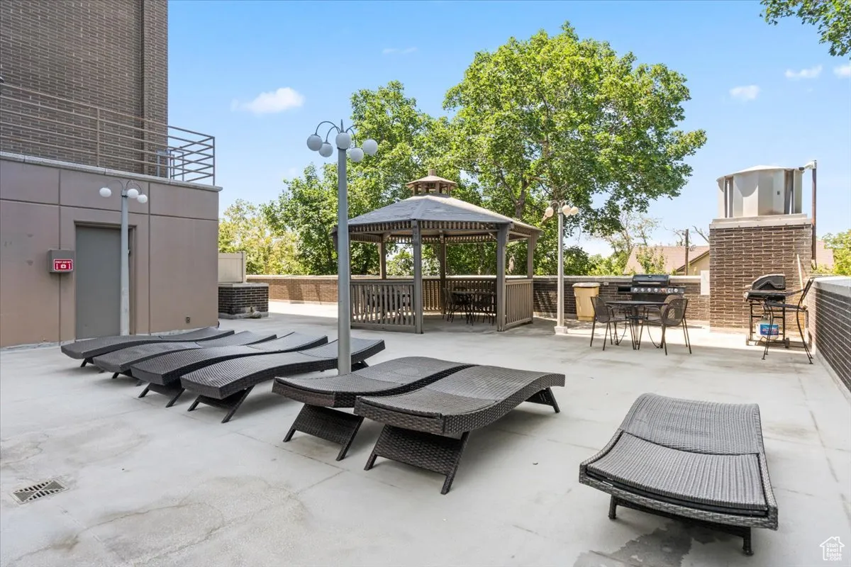 View of patio / terrace with a gazebo, area for grilling, and outdoor dining area