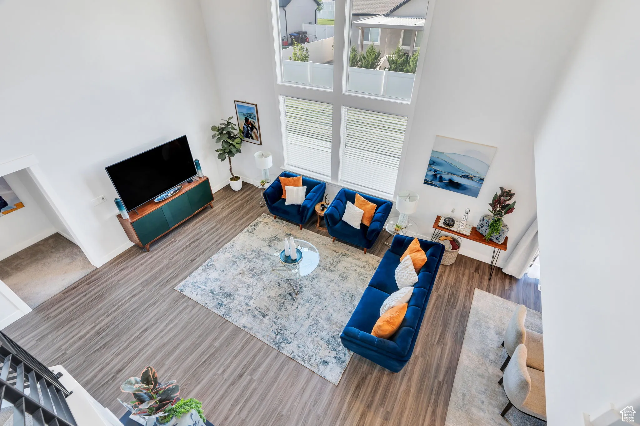 Living area featuring a towering ceiling and wood finished floors
