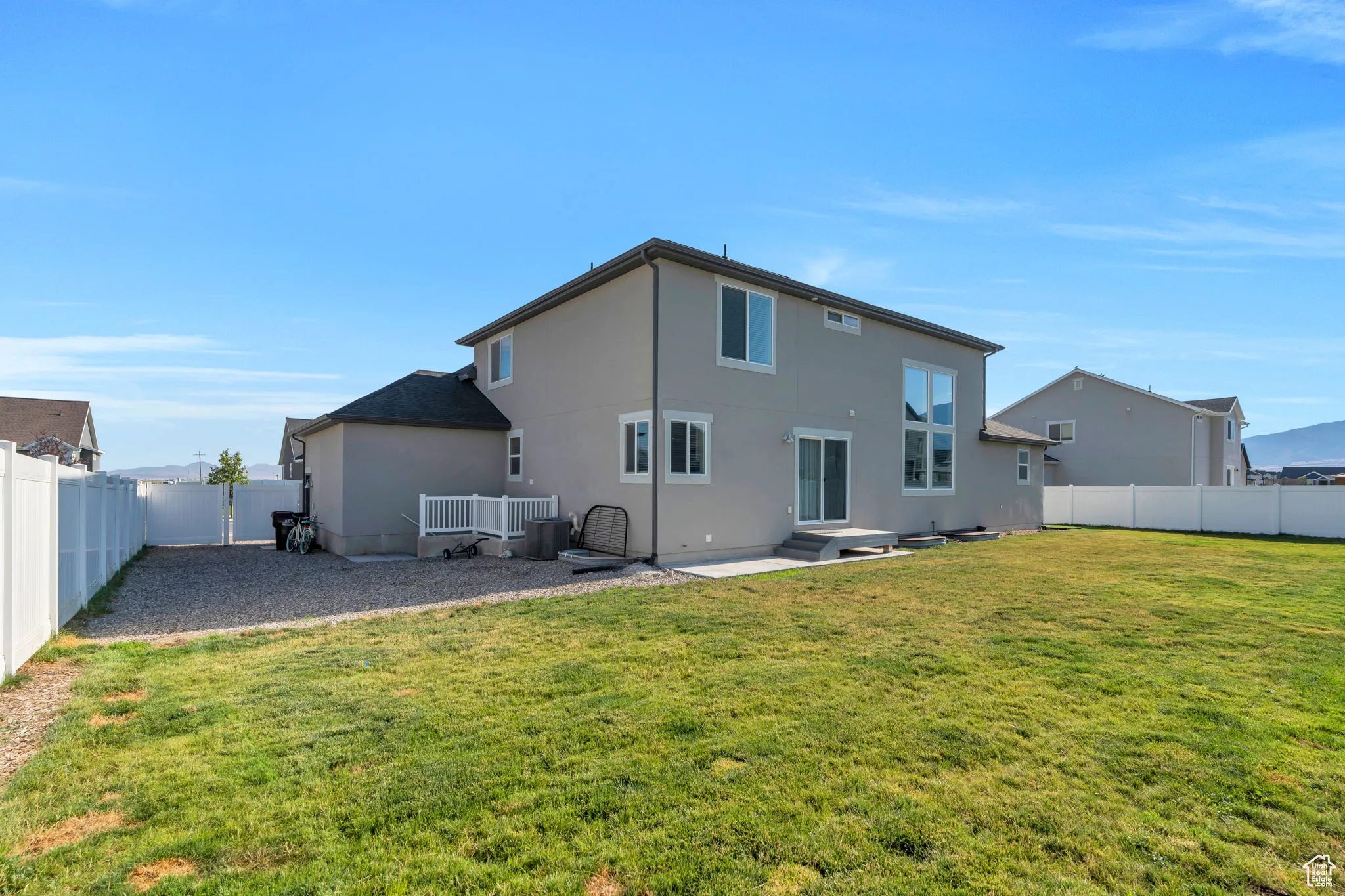Back of house featuring a fenced backyard, stucco siding, and a patio