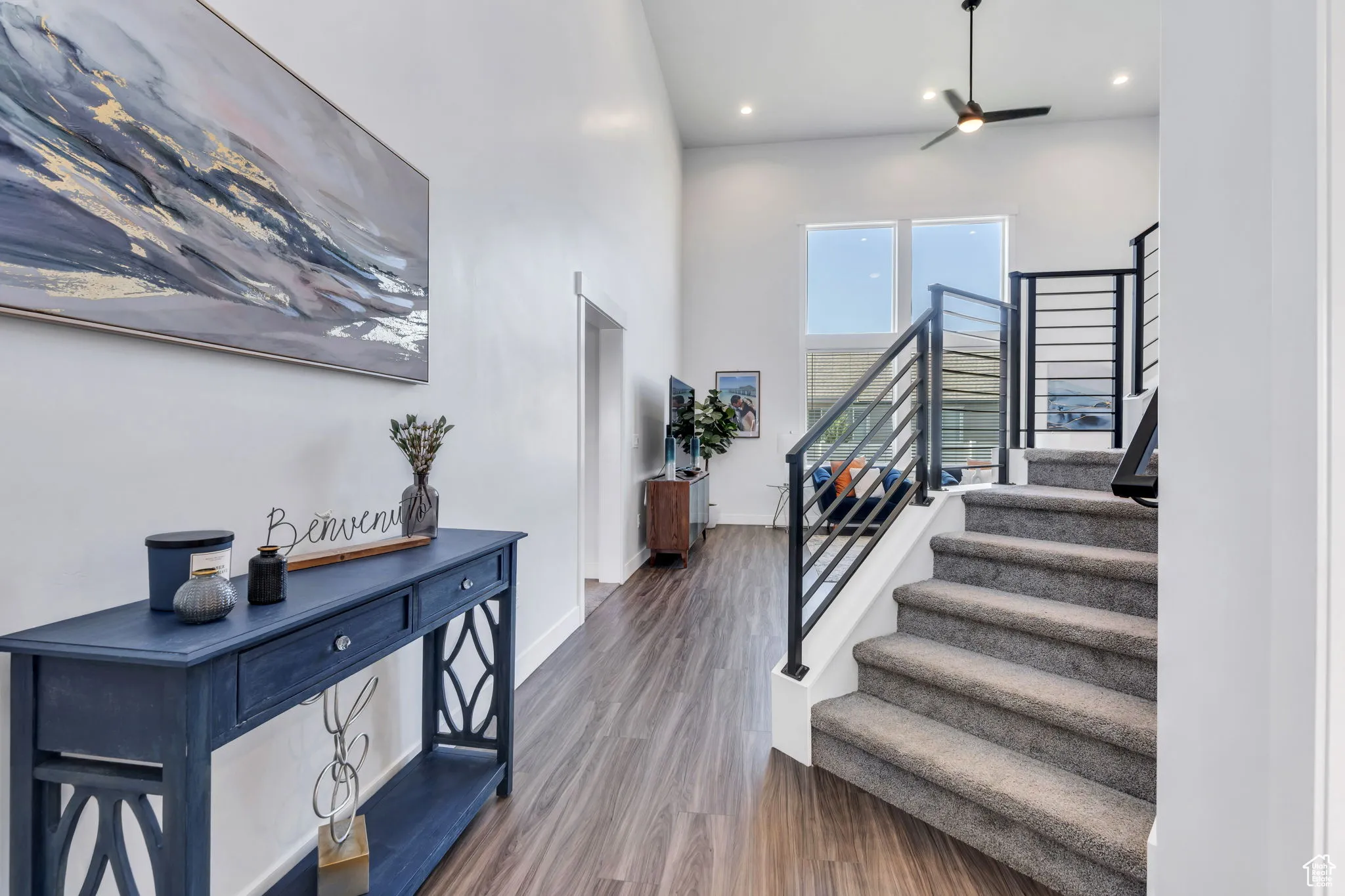 Entryway with stairs, wood finished floors, and recessed lighting